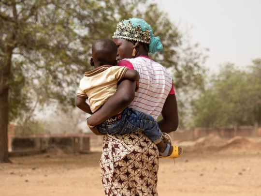 A mother carrying her toddler in Burkina Faso
