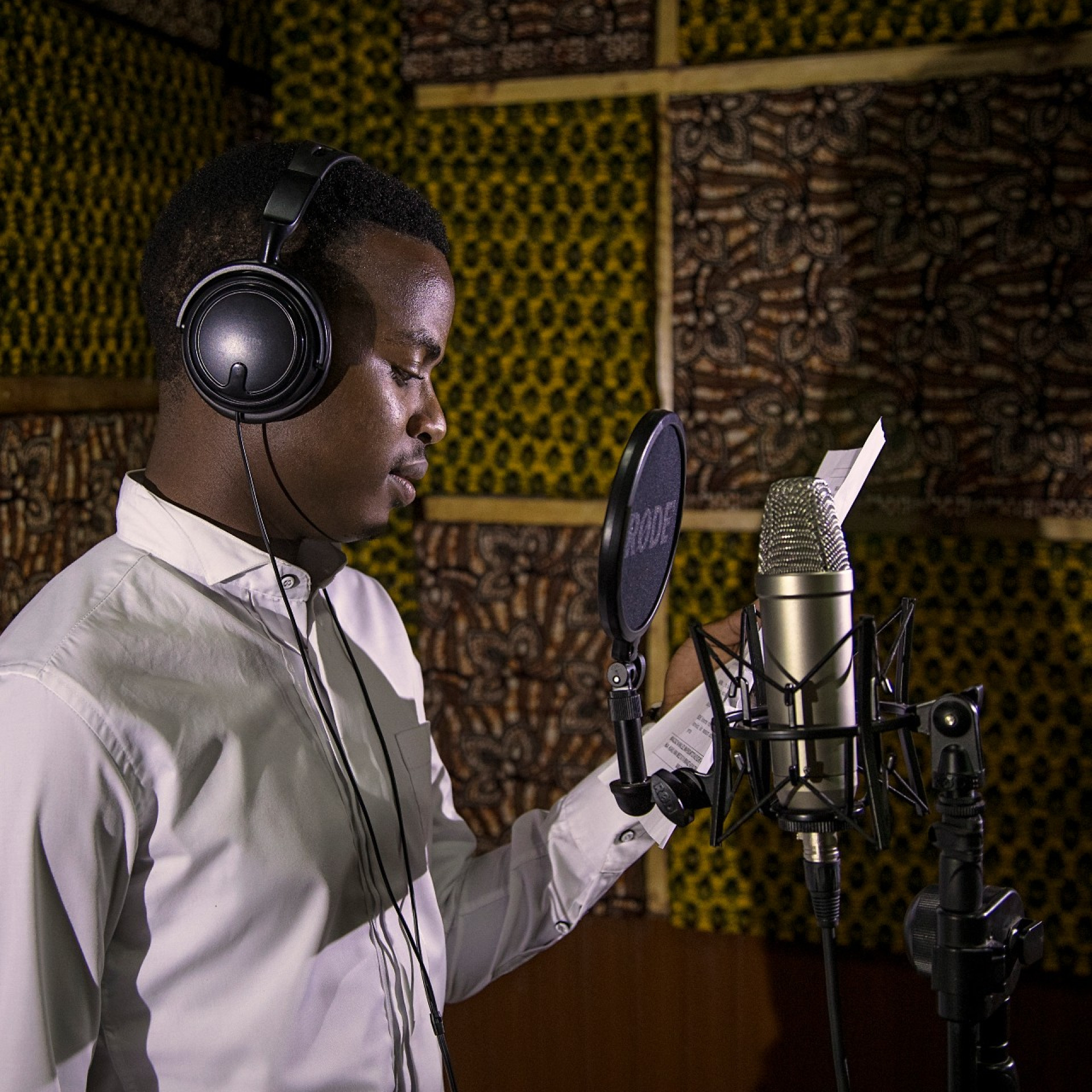 A man in a recording studio demonstrating DMI producing radio spots for this campaign